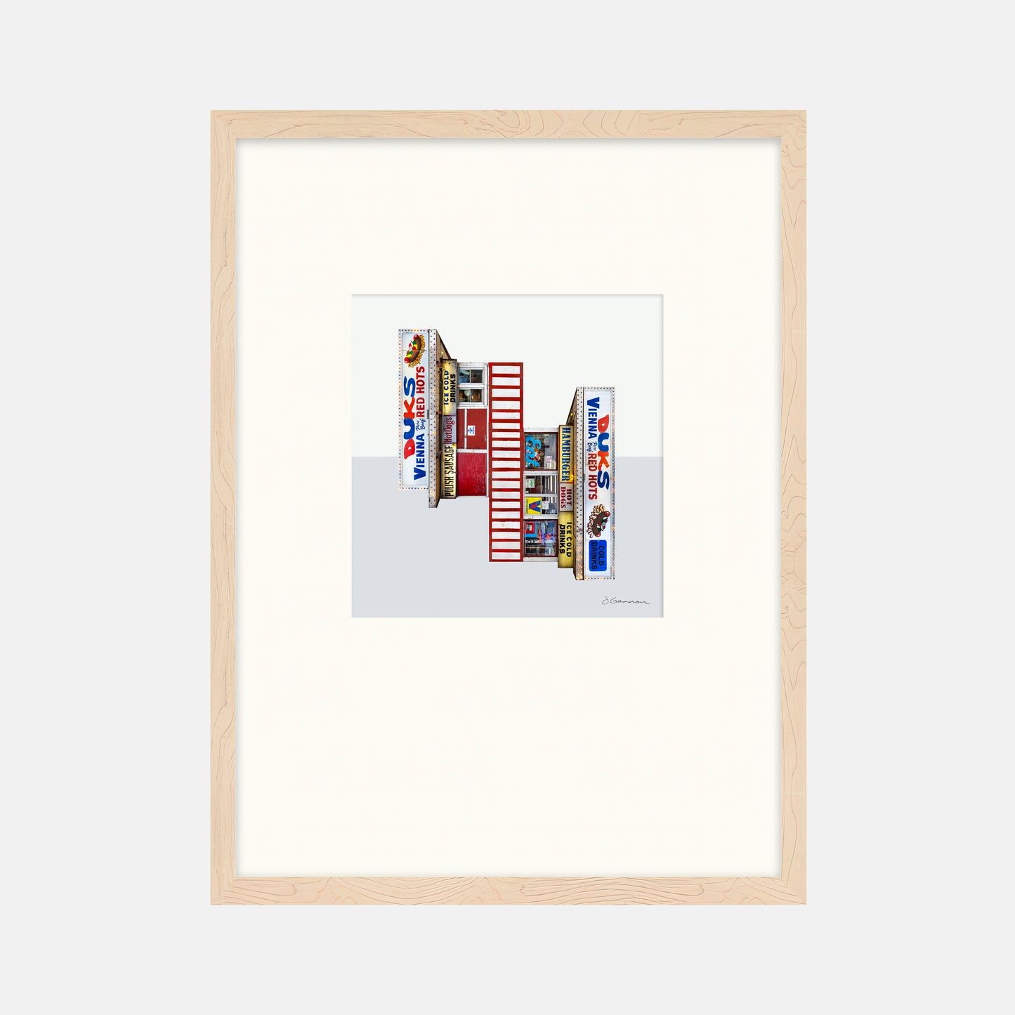 Framed artwork of a colorful building facade with 'Duks' branding on a white background